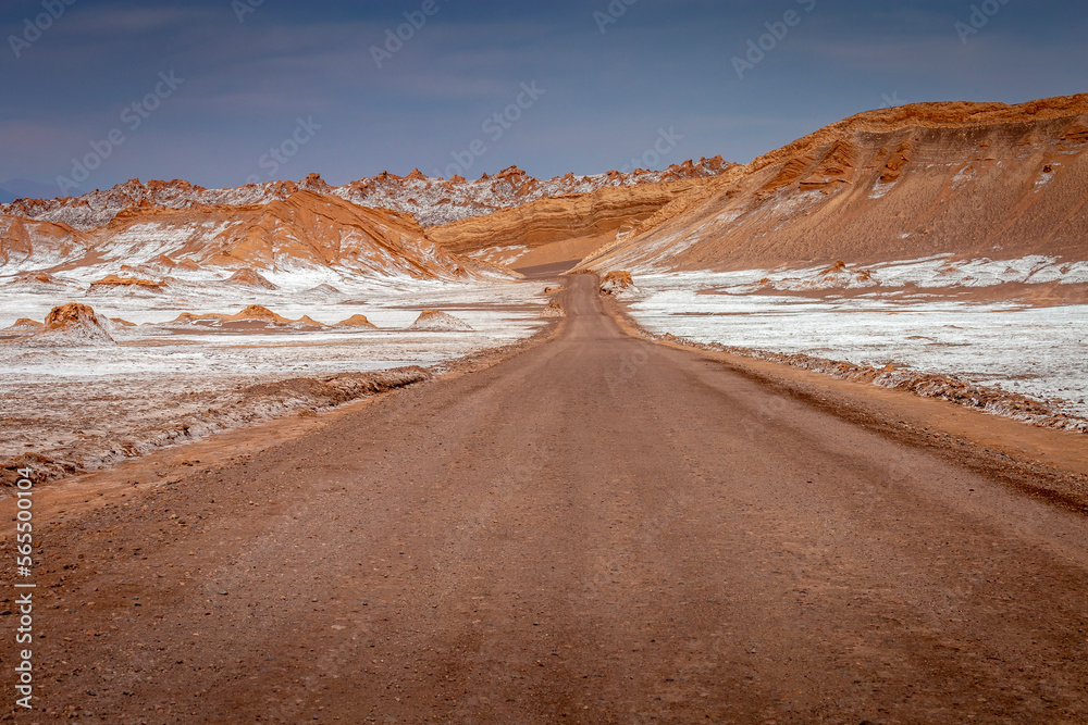 Dirt road in Moon Valley dramatic landscape at Sunset, Atacama Desert, Chile