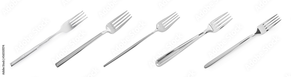 Set of shiny metal forks on white background