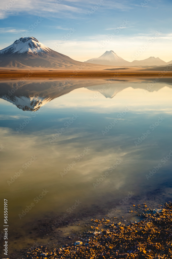 Salt lake Lejia reflection, idyllic volcanic landscape at Sunset, Atacama, Chile