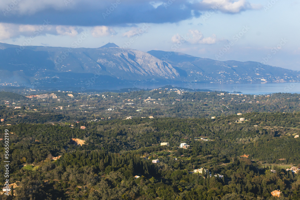 Corfu island view from Kaiser's Throne observation deck lookout, Pelekas village, Greece, Kaiser William II summit Observatory panoramic summer view with mountains, sea and Kerkyra in a background Corfu island view from Kaiser's Throne observation deck lookout, Pelekas village, Greece, Kaiser William II summit Observatory panoramic summer view with mountains, sea and Kerkyra in a background