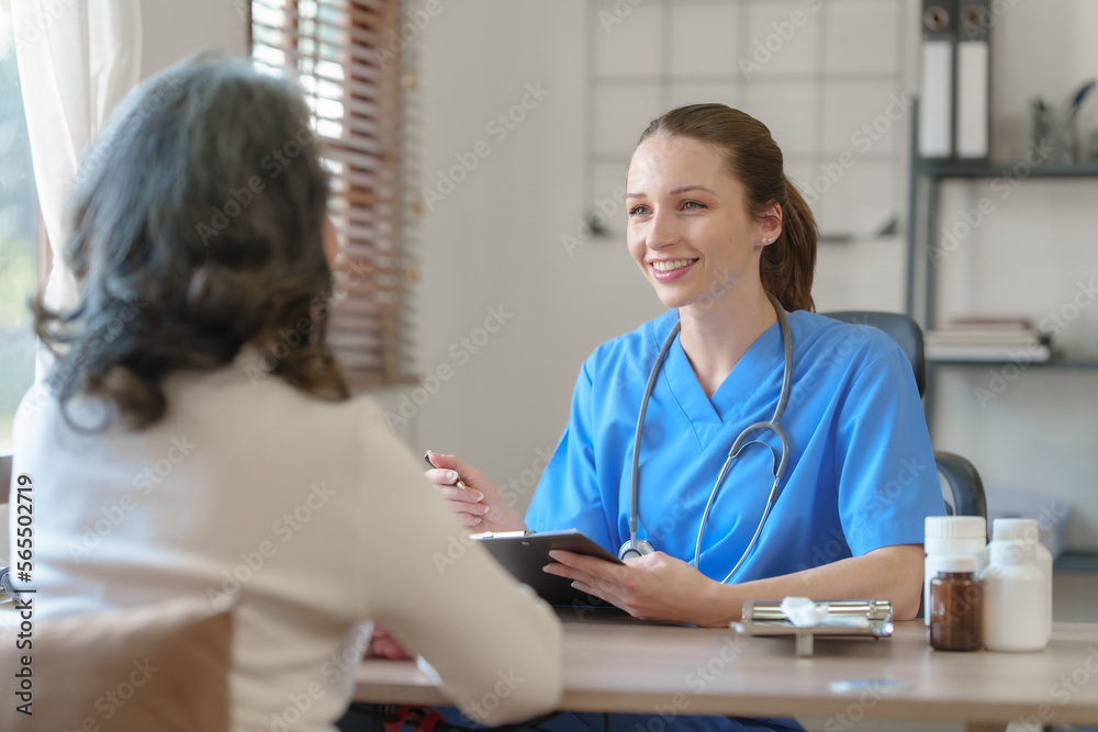 Fototapeta premium Female doctor taking a history of a patient and counseling on orthopedic diseases with female patients after measuring blood pressure and heart rate in a medical facility