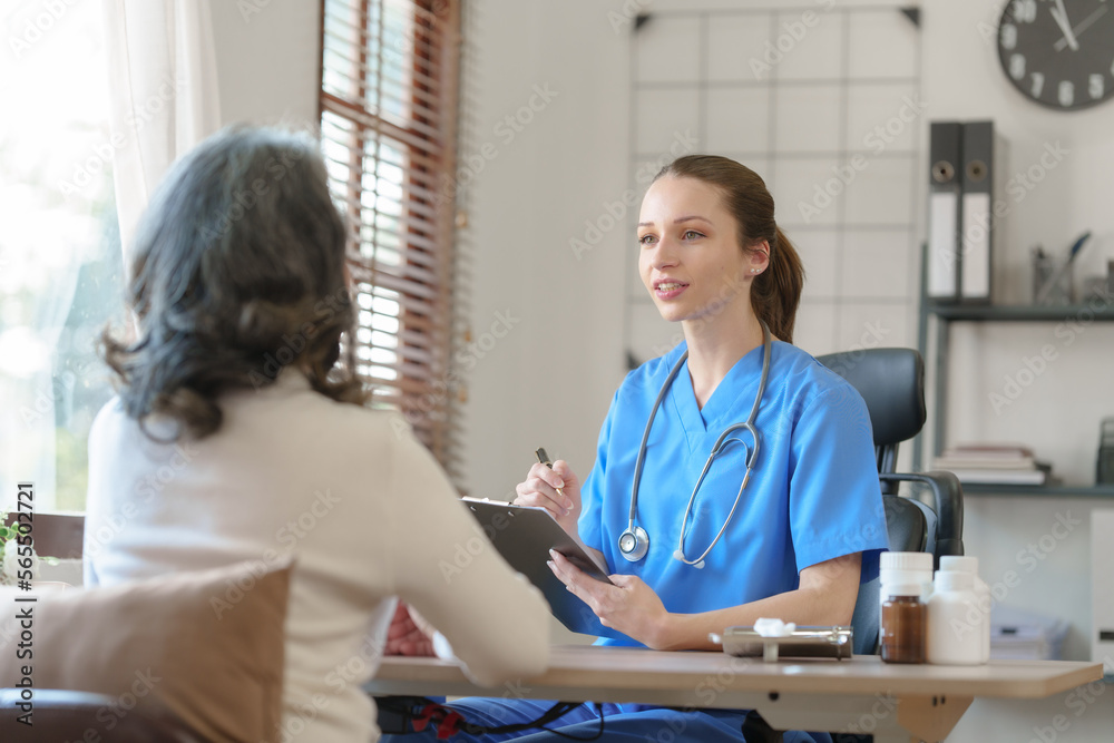Fototapeta premium Female doctor taking a history of a patient and counseling on orthopedic diseases with female patients after measuring blood pressure and heart rate in a medical facility
