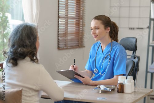 Female doctor taking a history of a patient and counseling on orthopedic diseases with female patients after measuring blood pressure and heart rate in a medical facility