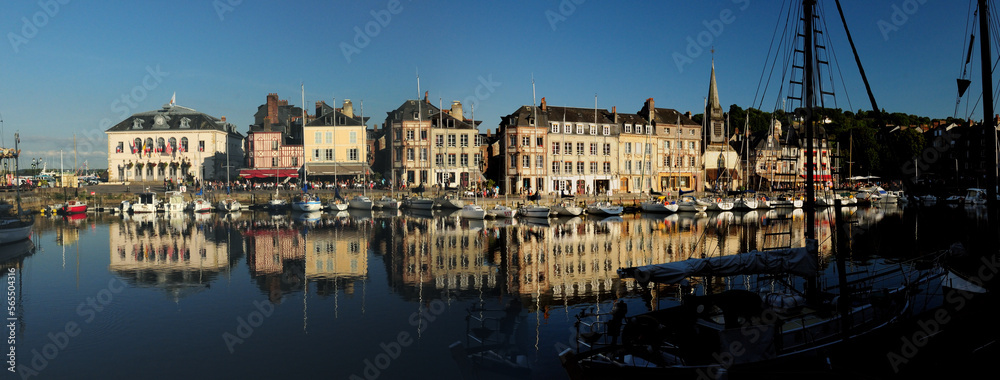 Historic Buildings Reflecting In The Water Of The Old Harbour In Honfleur Normandy France On A Beautiful Sunny Summer Day With A Clear Blue Sky