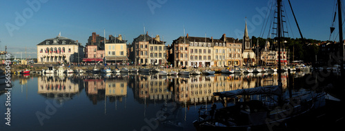 Historic Buildings Reflecting In The Water Of The Old Harbour In Honfleur Normandy France On A Beautiful Sunny Summer Day With A Clear Blue Sky © Joerg