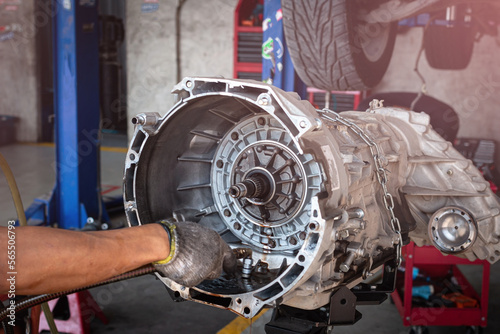 Auto mechanic working on car automatic transmission in auto repair shop. Welding for strengthen anchor pin of plate and torque  Converter for Automatic Transmission