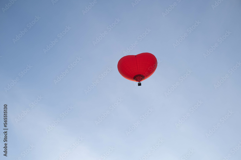 A colorful balloon in the shape of a heart, flying at sunset across the blue sky. Happy Valentine's Day Concept. space for text. A colorful balloon in the shape of a heart, flying at sunset across the blue sky. Happy Valentine's Day Concept. space for text.