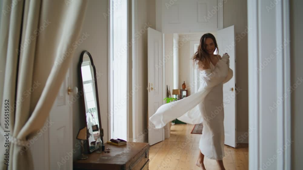 Cheerful woman running morning apartment alone. Positive lady dancing at house