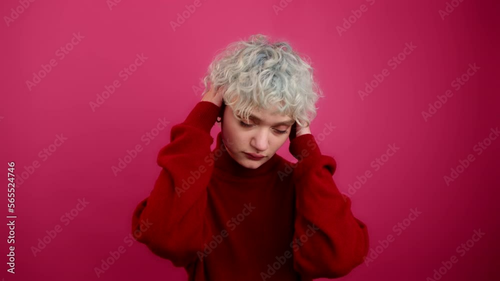 Close-up shot of a beautiful female model during a studio shot. Portrait of glamorous model touching her head and hair. High quality 4k footage Close-up shot of a beautiful female model during a studio shot. Portrait of glamorous model touching her head and hair. High quality 4k footage