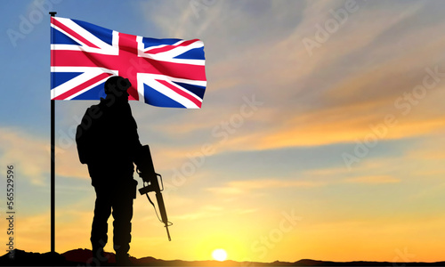 Silhouette of soldier with United Kingdom flag on background of sky. Background for Remembrance Day. United Kingdom Armed Forces concept. EPS10 vector