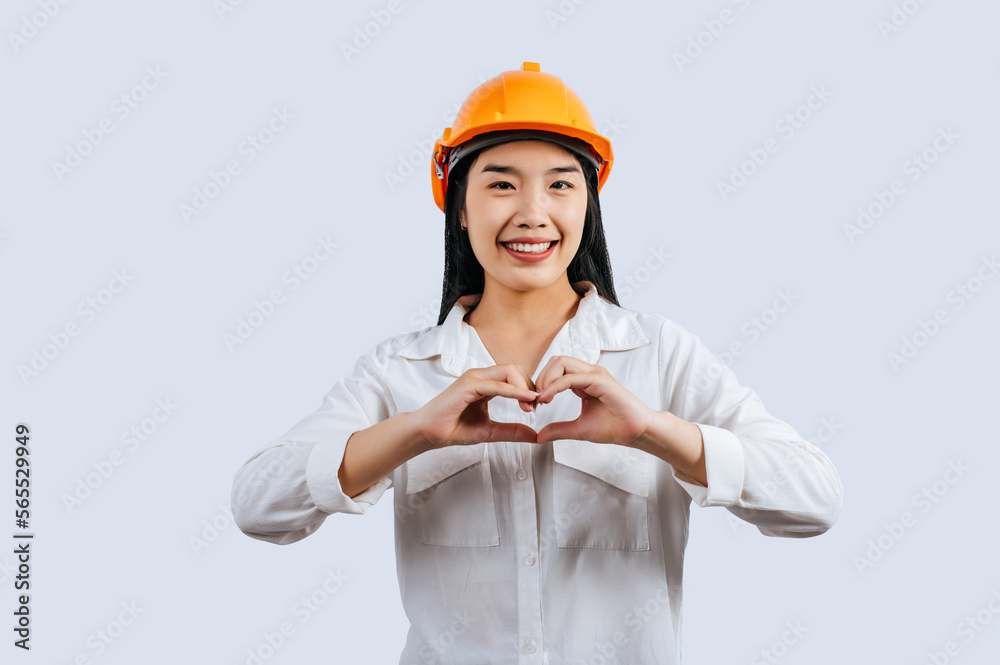 Young female engineer wearing Yellow helmet and hand sign posture Young female engineer wearing Yellow helmet and hand sign posture
