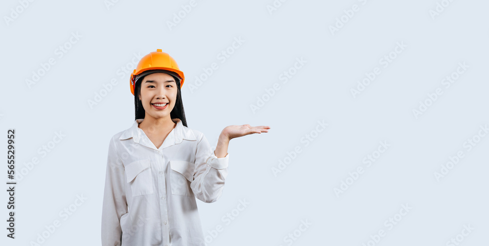 Young asian engineer female standing with open palm posture Young asian engineer female standing with open palm posture
