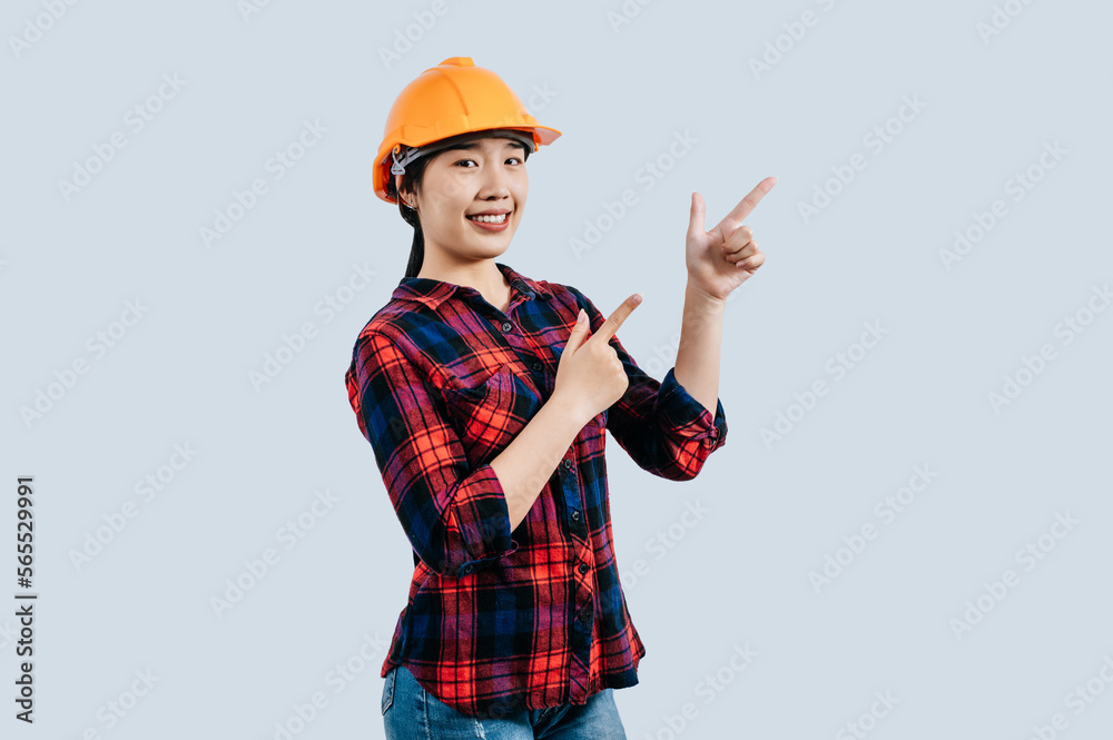 Young asian engineer female standing with point finger posture Young asian engineer female standing with point finger posture