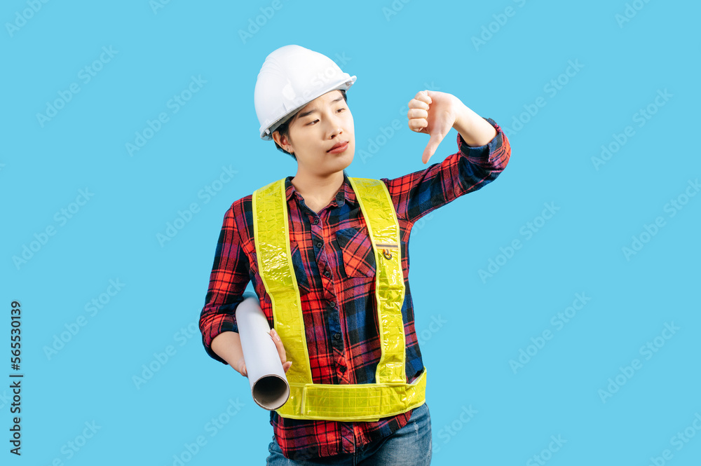 Young asian engineer female wearing safety jacket and helmet hold blue print Young asian engineer female wearing safety jacket and helmet hold blue print