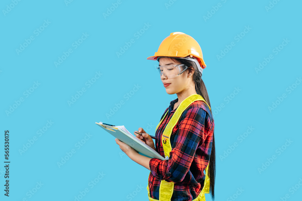Young asian engineer female use pen to check list on clipboard posture Young asian engineer female use pen to check list on clipboard posture