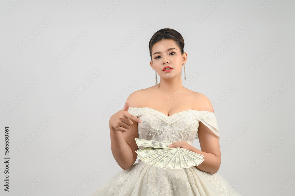 Young asian beautiful bride holding dollar bills in hand Young asian beautiful bride holding dollar bills in hand