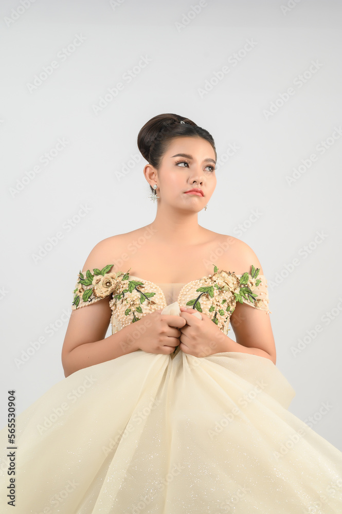 Portrait of beautiful Asian bride grimace in luxurious wedding dress Portrait of beautiful Asian bride grimace in luxurious wedding dress