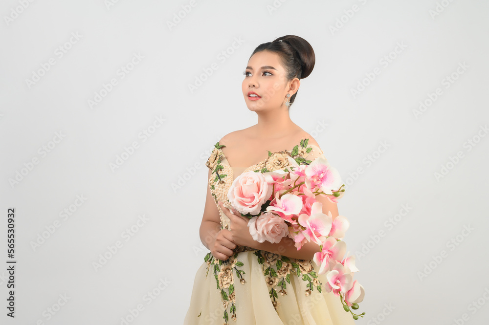 Young asian beautiful bride with orchid bouquet on white background Young asian beautiful bride with orchid bouquet on white background