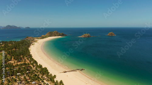 Tropical island with sandy beach, aerial view. Nacpan, El Nido, Palawan, Philippine Islands. Seascape with tropical beach and islands. Summer and travel vacation concept