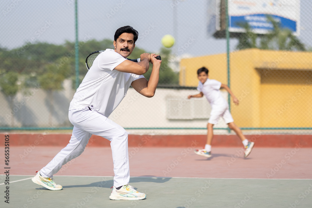Male tennis player ready to serve at tennis court. Male tennis player ready to serve at tennis court.