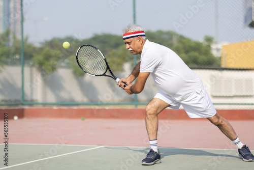 Senior man tennis player on tennis court. © G-images