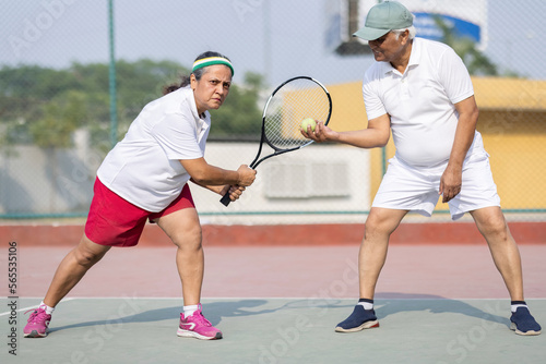 Beautiful young girl on an open tennis court playing tennis.