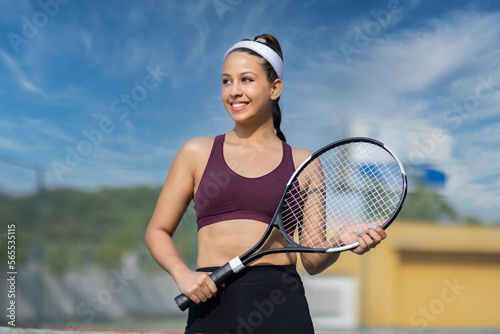 Beautiful young girl on an open tennis court playing tennis. © G-images