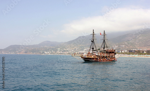 Cargo ship at sea. transit ship. Sailboats. Fishing boat. Fishing. Sightseeing Boat. Boat, ship floating in blue waters. Sunburns and ship reflecting from the sea. Cruise