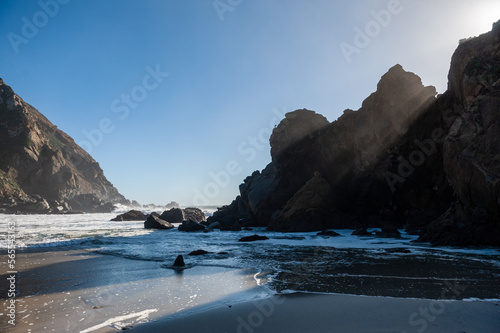Late afternoon impression of Pfeiffer beach, California on a bright sunny afternoon as the sun is about to set. photo