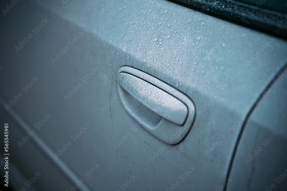 Frosted ice car door handle covered with ice crystals. the iced vehicle handle. Concept of a frosty morning