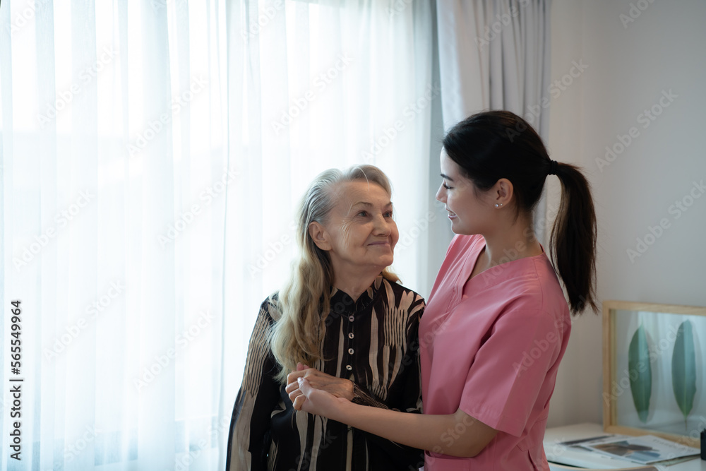 Fototapeta premium Caregiver for an elderly woman Weekly check-ups at the patient's residence. Ready to give medical advice and talk about various stories, exchange each other happily.
