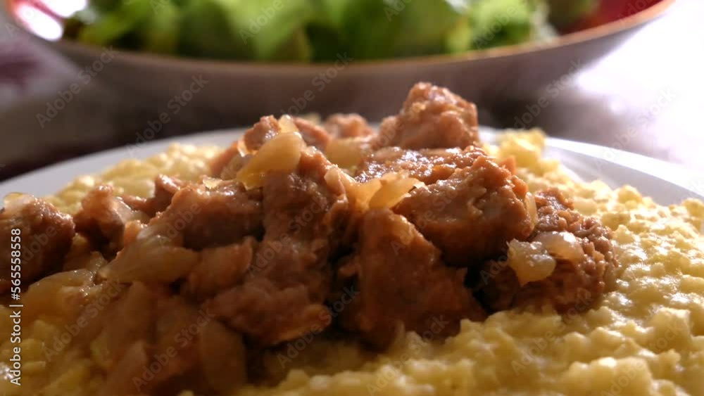 Hot couscous meal with meat and greens in a plate, traditional Arabic food