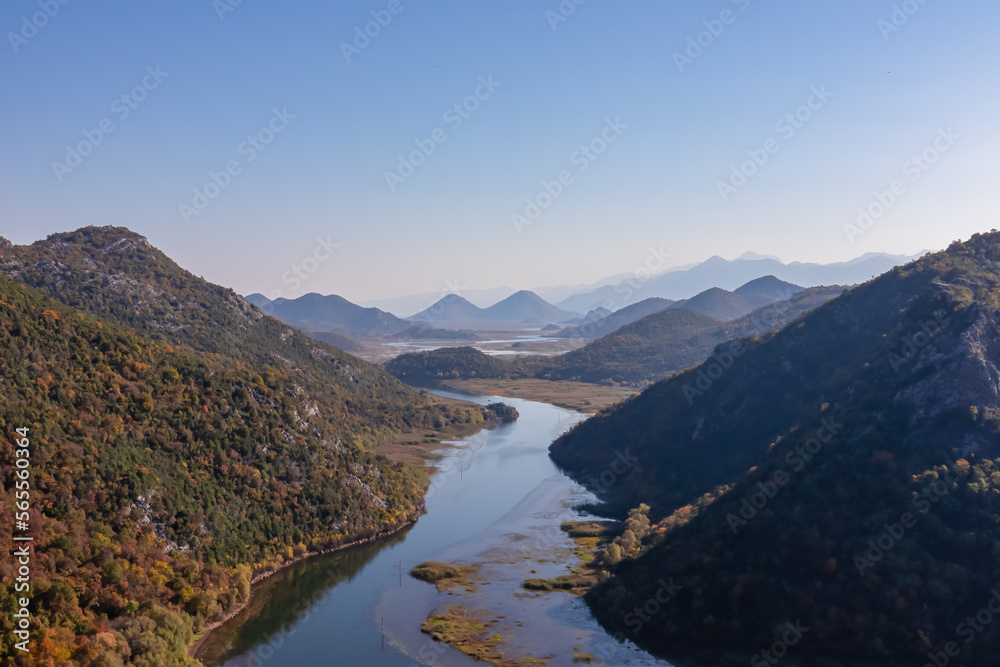 Scenic view from Pavlova Strana on horseshoe bend of river Crnojevica winding around Dinaric Alps mountains in Lake Skadar National Park, Bar, Montenegro, Balkans, Europe. Natural hilly landscape