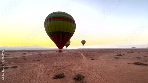 Colorful hot air balloons flying over the desert in Morocco