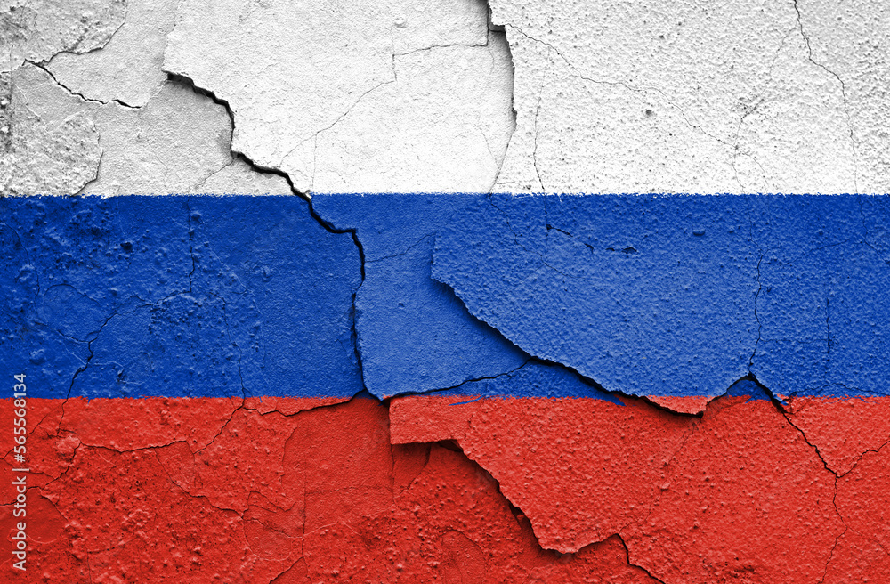 Flag of Russia painted on a craced wall. Embargo and sanctions for military aggression. 