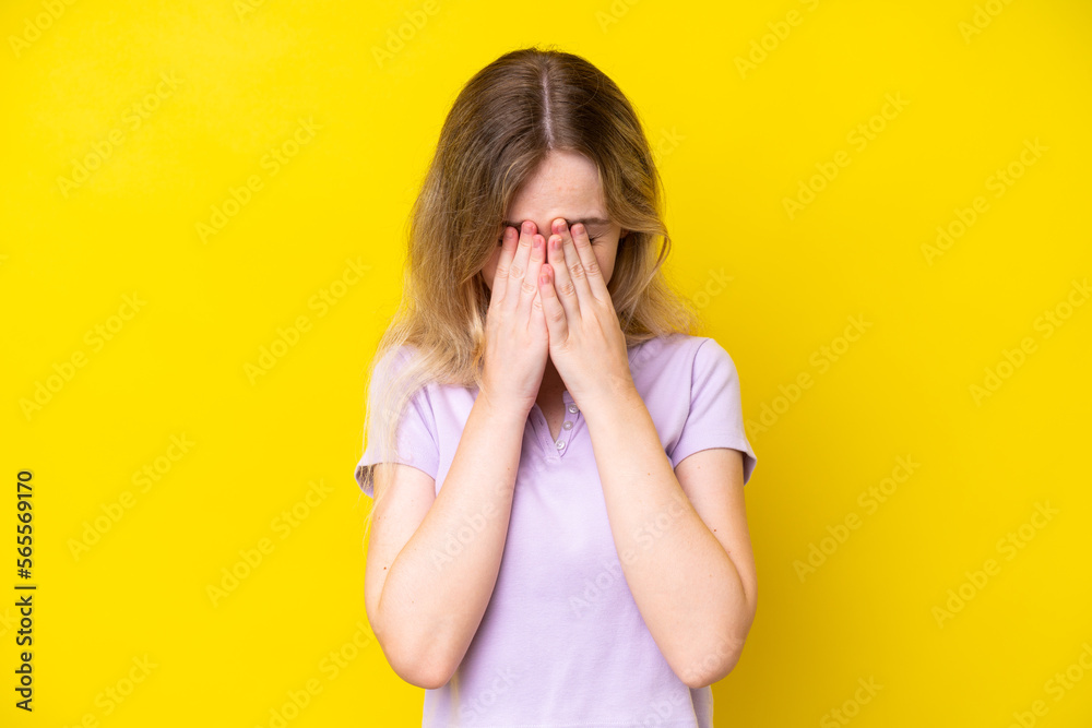 Blonde English young girl isolated on yellow background with tired and sick expression
