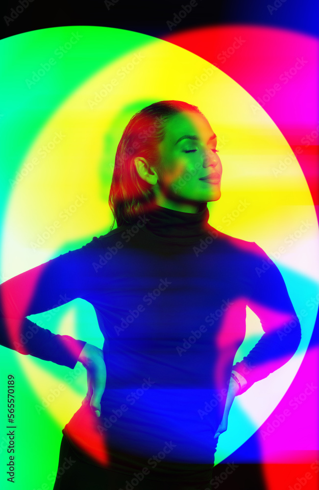 Sexy looking woman with black turtle neck sweater, tight trousers and wet hair style studio portrait. Model with closed eyes. Vivid RGB color split effect applied. Futuristic looking style