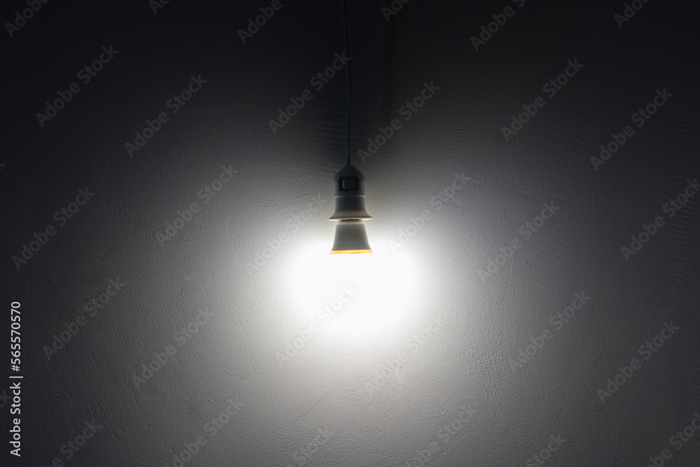simple light bulb hanging near the wall at home simple light bulb hanging near the wall at home