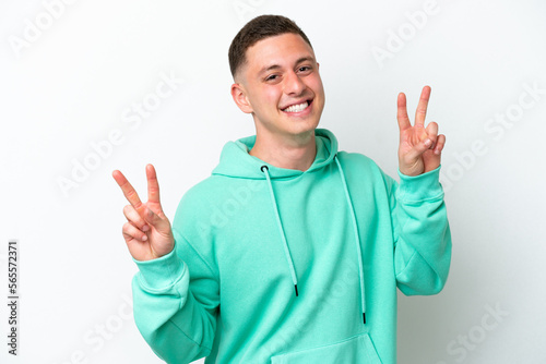Young brazilian man isolated on white background showing victory sign with both hands © luismolinero