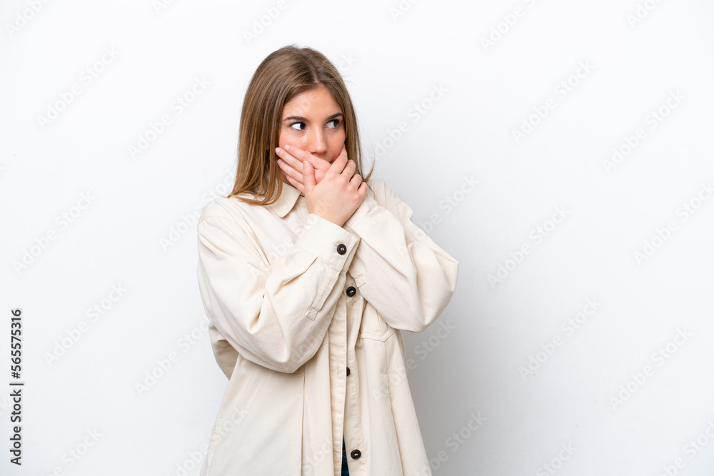 Young caucasian woman isolated on white bakcground covering mouth and looking to the side