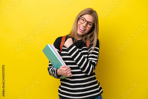Young student woman isolated on yellow background background celebrating a victory