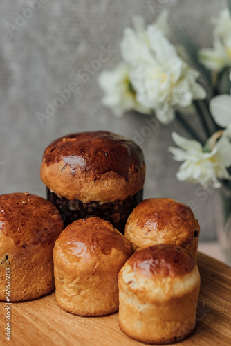 Delicious Easter cakes on a wooden table with flowers in the background. place for text. selective focus