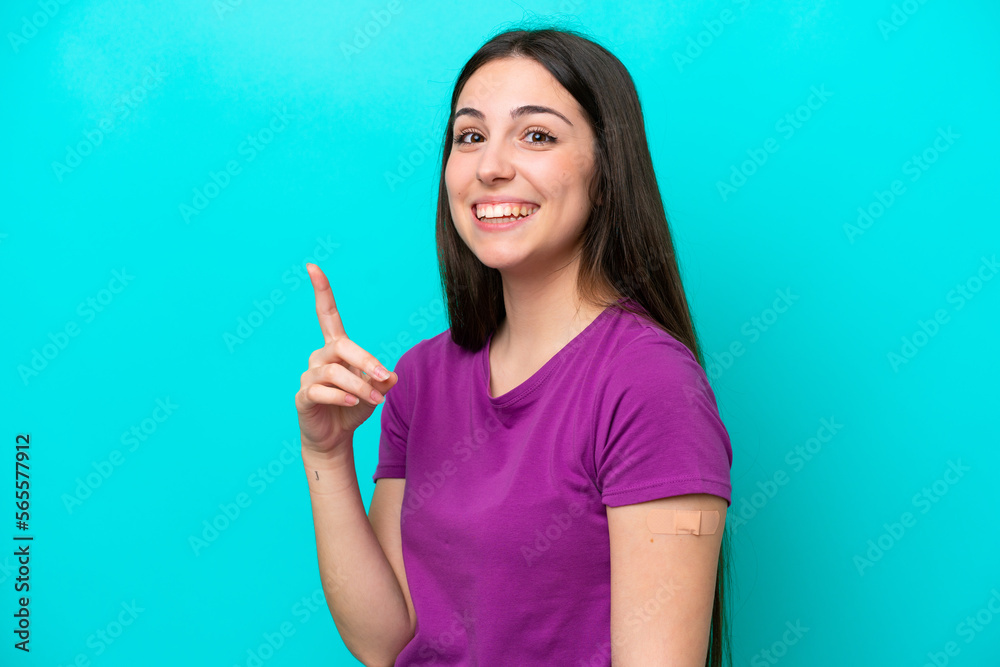 Young girl with band-aids isolated on blue background intending to realizes the solution while lifting a finger up Young girl with band-aids isolated on blue background intending to realizes the solution while lifting a finger up