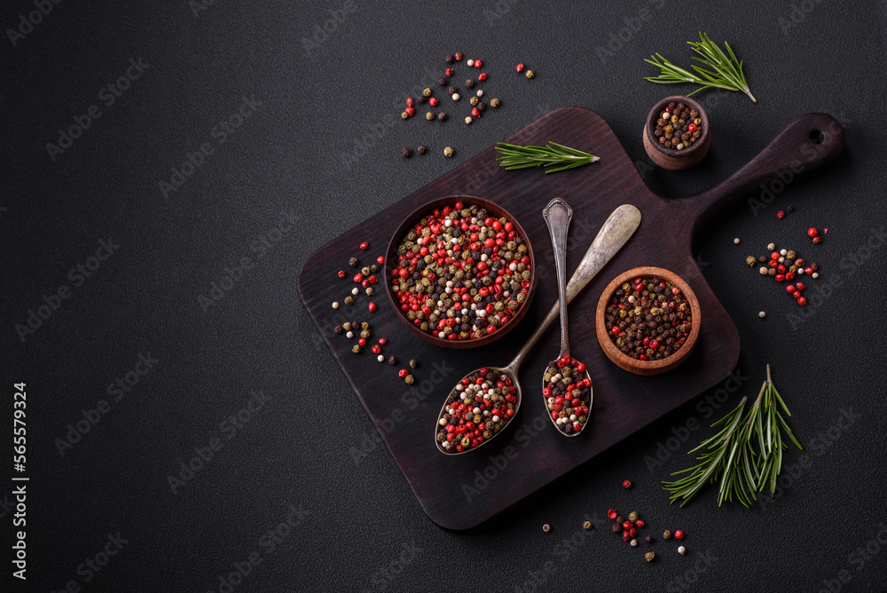 Fototapeta premium Spice allspice of different colors pink, white, green not ground in a wooden saucer