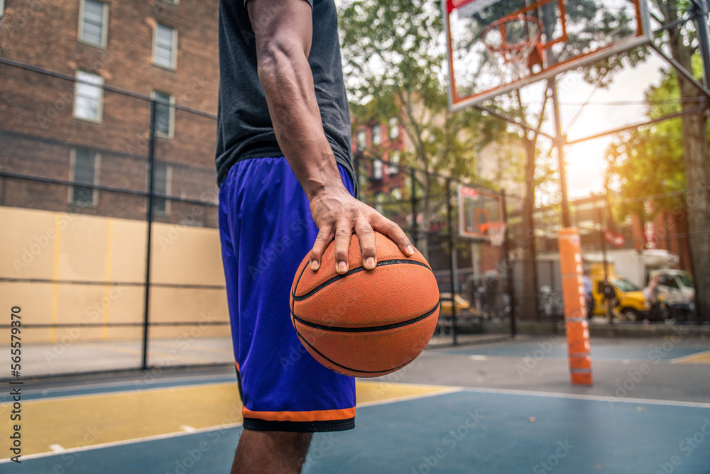 Athletic african american basketball player training on a court in New York - Sportive man playing basket outdoors Athletic african american basketball player training on a court in New York - Sportive man playing basket outdoors