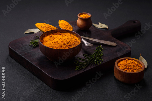 Fototapeta Naklejka Na Ścianę i Meble -  Bright yellow turmeric or curry spice for Asian food preparation