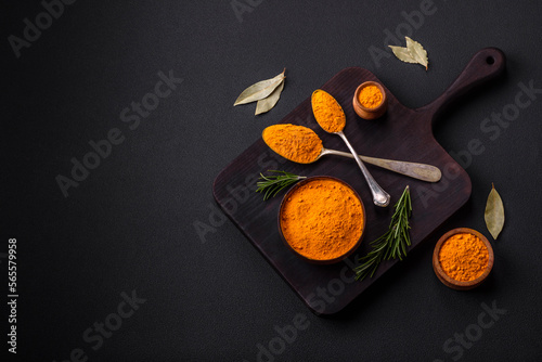 Fototapeta Naklejka Na Ścianę i Meble -  Bright yellow turmeric or curry spice for Asian food preparation