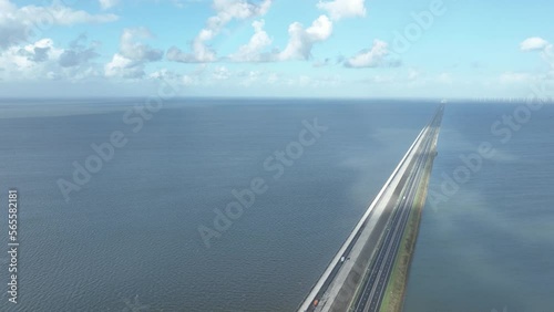 Aerial drone video of the Afsluitdijk in The Netherlands showcasing the 32-kilometer long sea barrier and the picturesque landscapes. photo