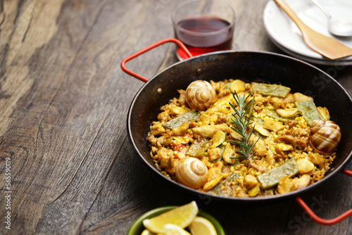 Spanish Valencian traditional paella; rabbit, chicken, garrofon beans, snails, Moroccan green beans, saffron, and bomba rice.