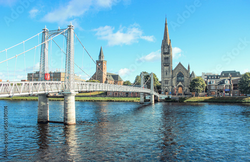 Greig St Bridge across Ness River and the Free Church of Scotland on the river bank in sunny days photo